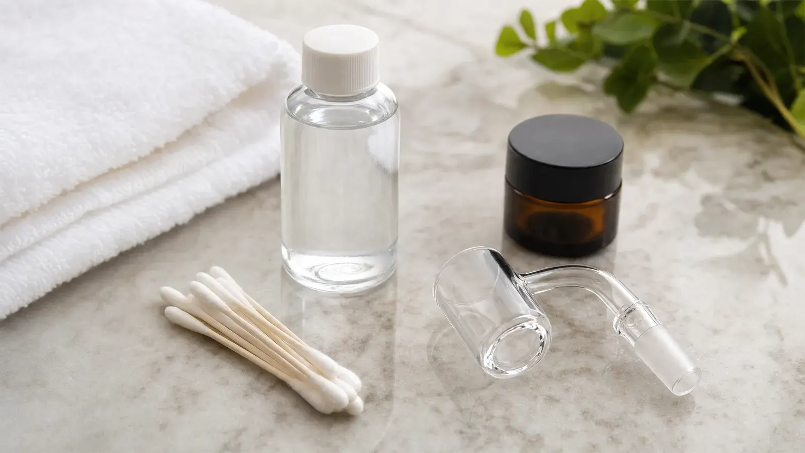 Cotton swabs, iso bottle, quartz banger, towel, and closed amber jar